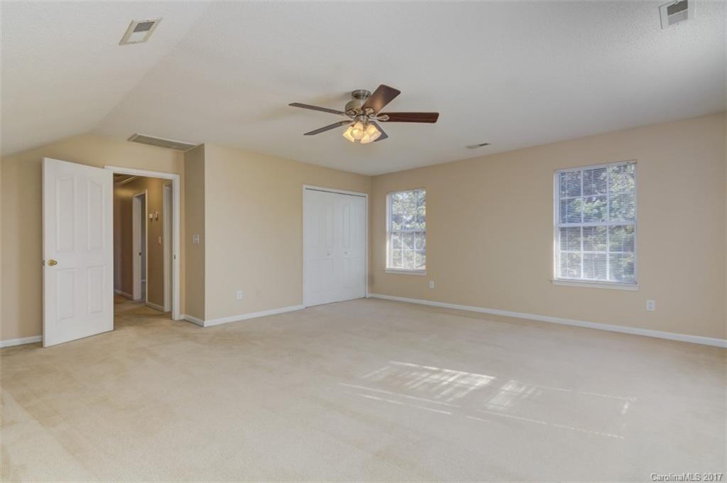 12206 Marathon Hill Road Charlotte, NC 28269 - Photo 15 of 23 an empty room with windows and fan