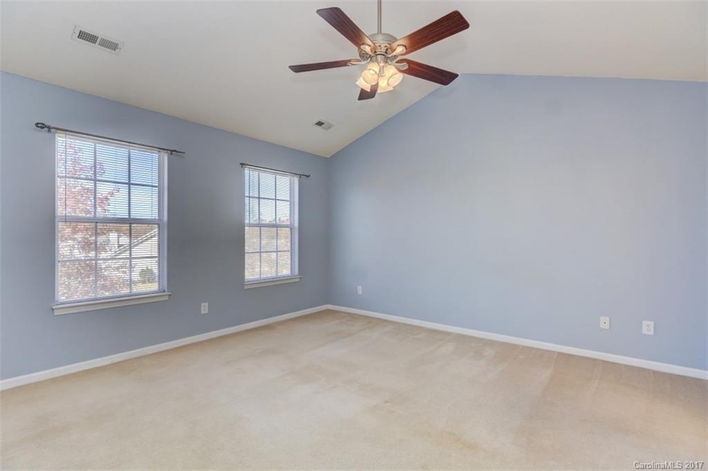 12206 Marathon Hill Road Charlotte, NC 28269 - Photo 17 of 23 an empty room with a window and a fan