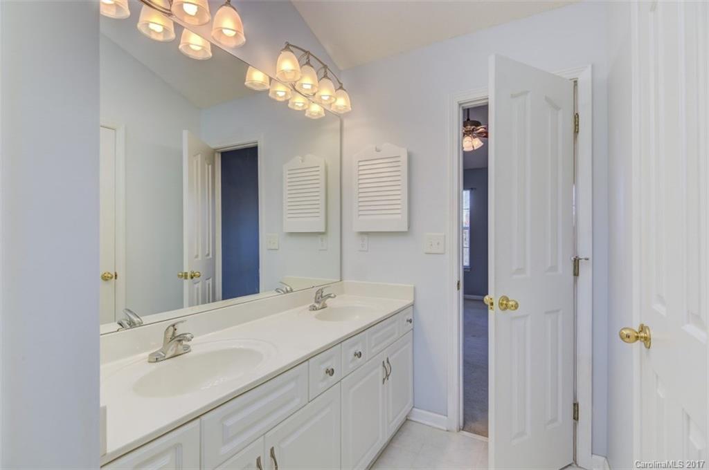 12206 Marathon Hill Road Charlotte, NC 28269 - Photo 19 of 23 a bathroom with a double vanity sink and a mirror