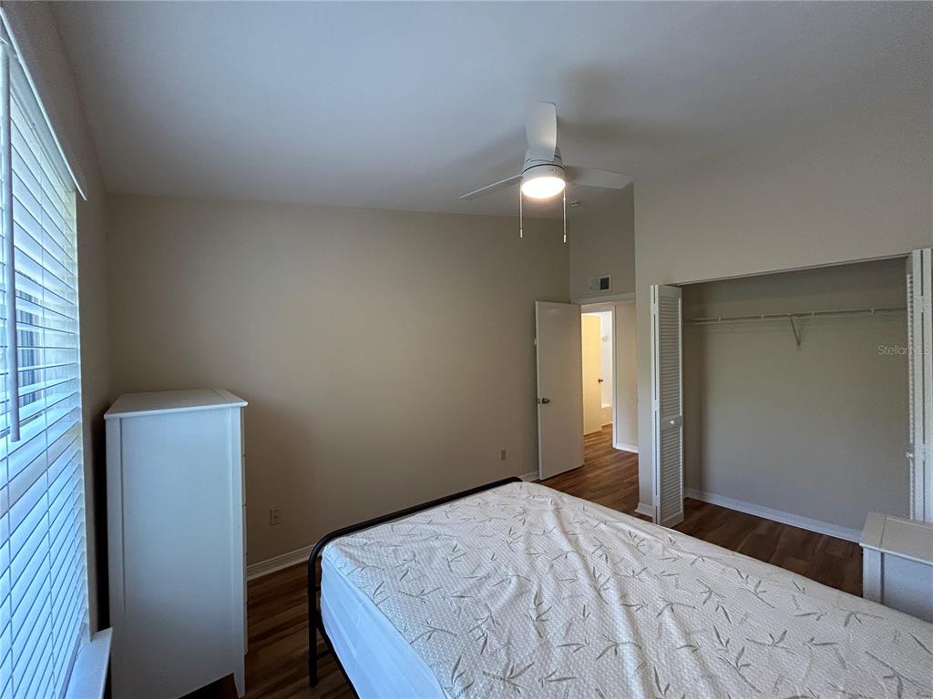 2360 Southwest Archer Road, Unit 1012 Gainesville, FL 32608 - Photo 17 of 28 a bedroom with a bed and a chandelier