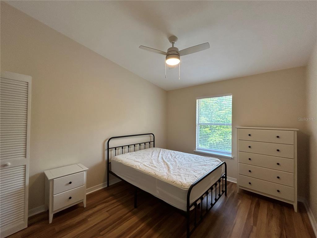 2360 Southwest Archer Road, Unit 1012 Gainesville, FL 32608 - Photo 18 of 28 a bedroom with a bed and a dresser