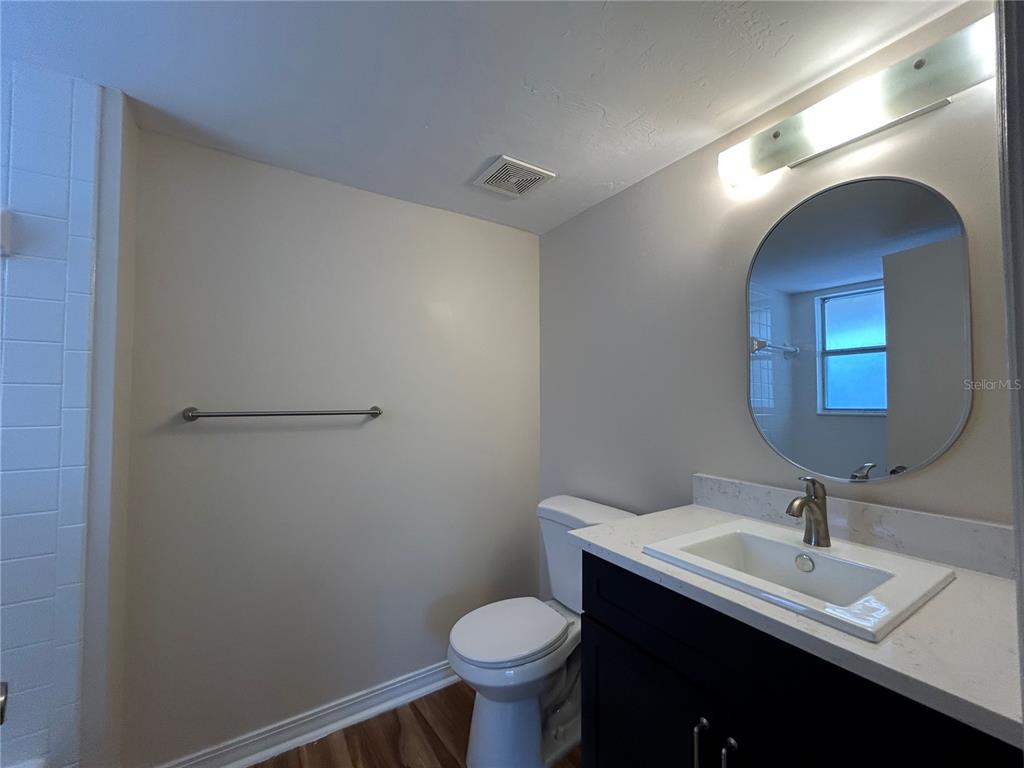 2360 Southwest Archer Road, Unit 1012 Gainesville, FL 32608 - Photo 20 of 28 a bathroom with a toilet sink and mirror