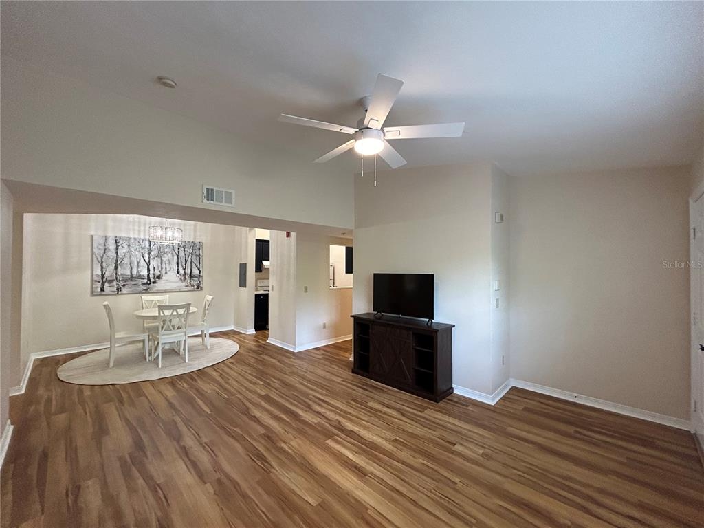 2360 Southwest Archer Road, Unit 1012 Gainesville, FL 32608 - Photo 2 of 28 a living room with furniture fireplace and a flat screen tv
