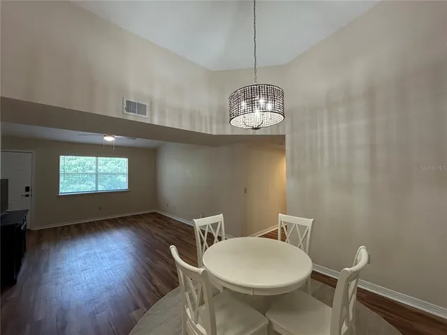 a view of a dining room with furniture wooden floor and chandelier