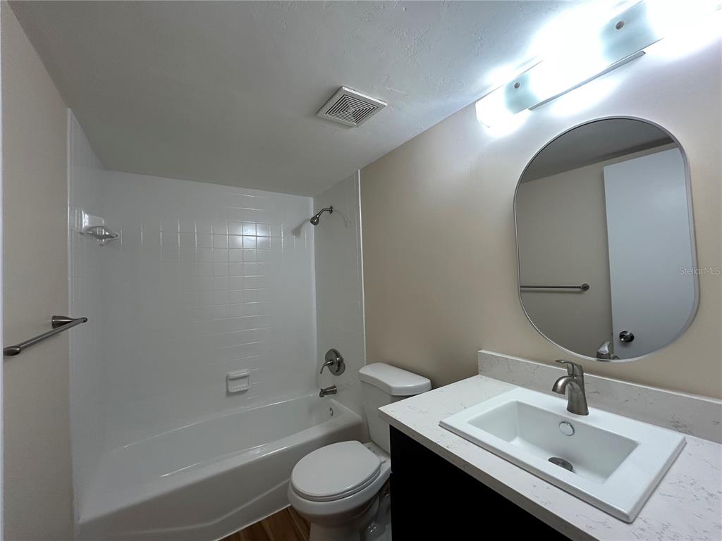 2360 Southwest Archer Road, Unit 1012 Gainesville, FL 32608 - Photo 10 of 28 a bathroom with a sink toilet and shower