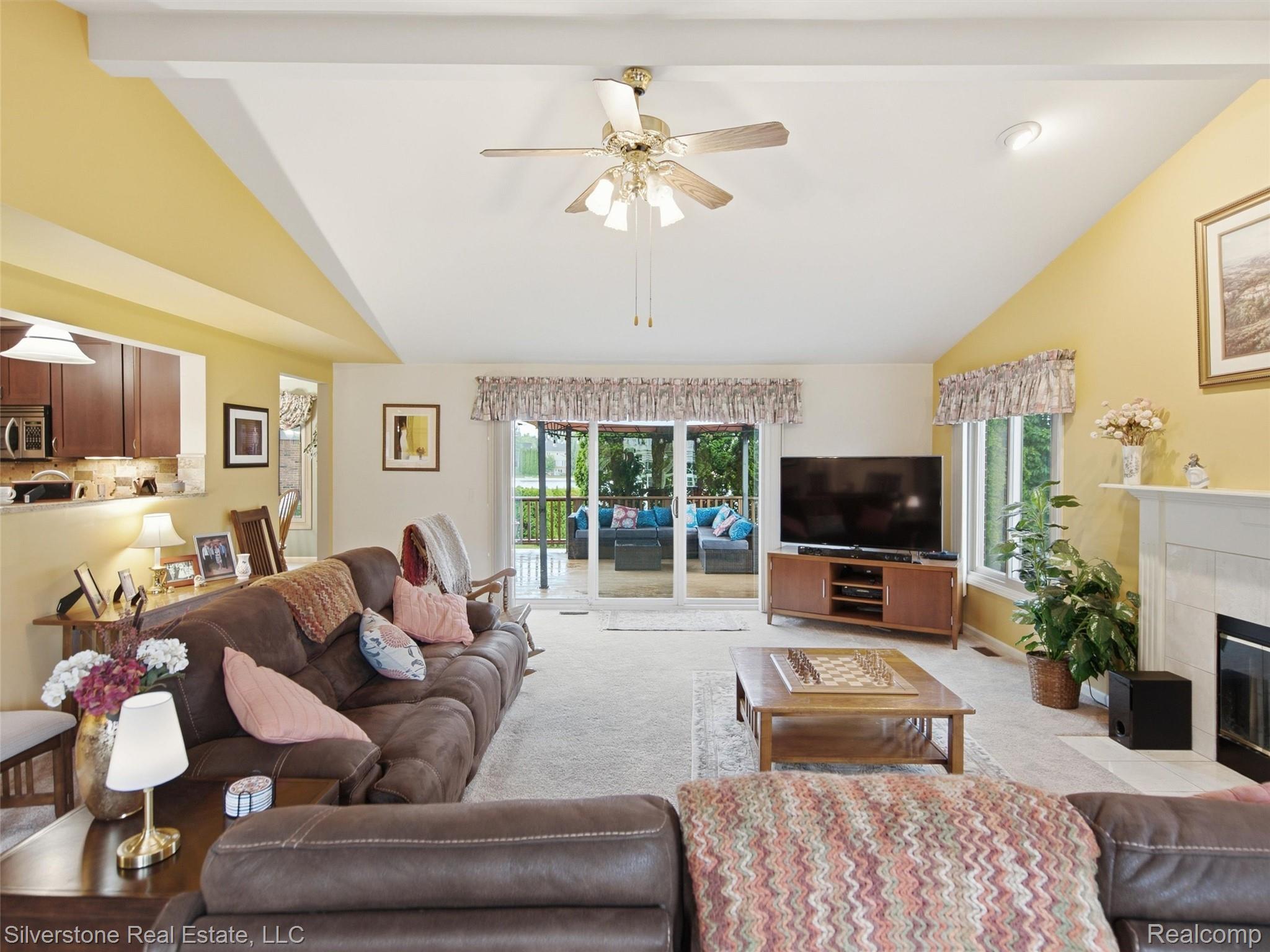 6577 Edith Court Troy, MI 48085 - Photo 14 of 61 Spacious living area featuring a vaulted ceiling with exposed beams, ceiling fan, and recessed lighting