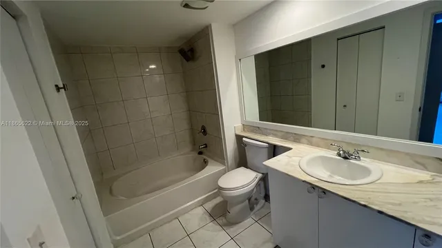 a bathroom with a sink mirror and toilet