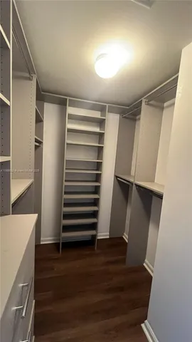 a view of walk in closet with empty racks
