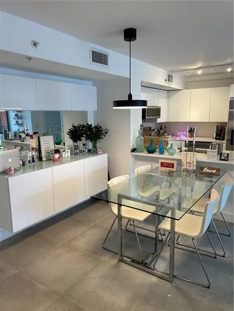 a kitchen with stainless steel appliances kitchen island granite countertop a sink and cabinets