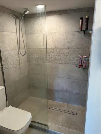 a bathroom with a toilet and shower