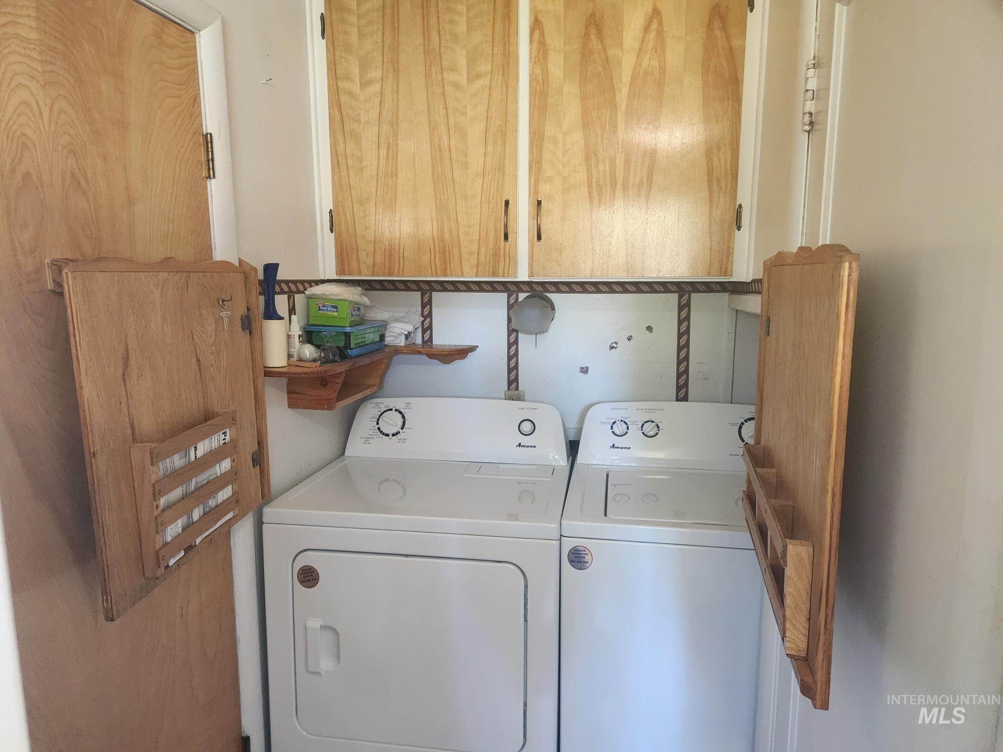909 12th Street Kamiah, ID 83536 - Photo 13 of 36 Washroom with cabinet space and washer and clothes dryer