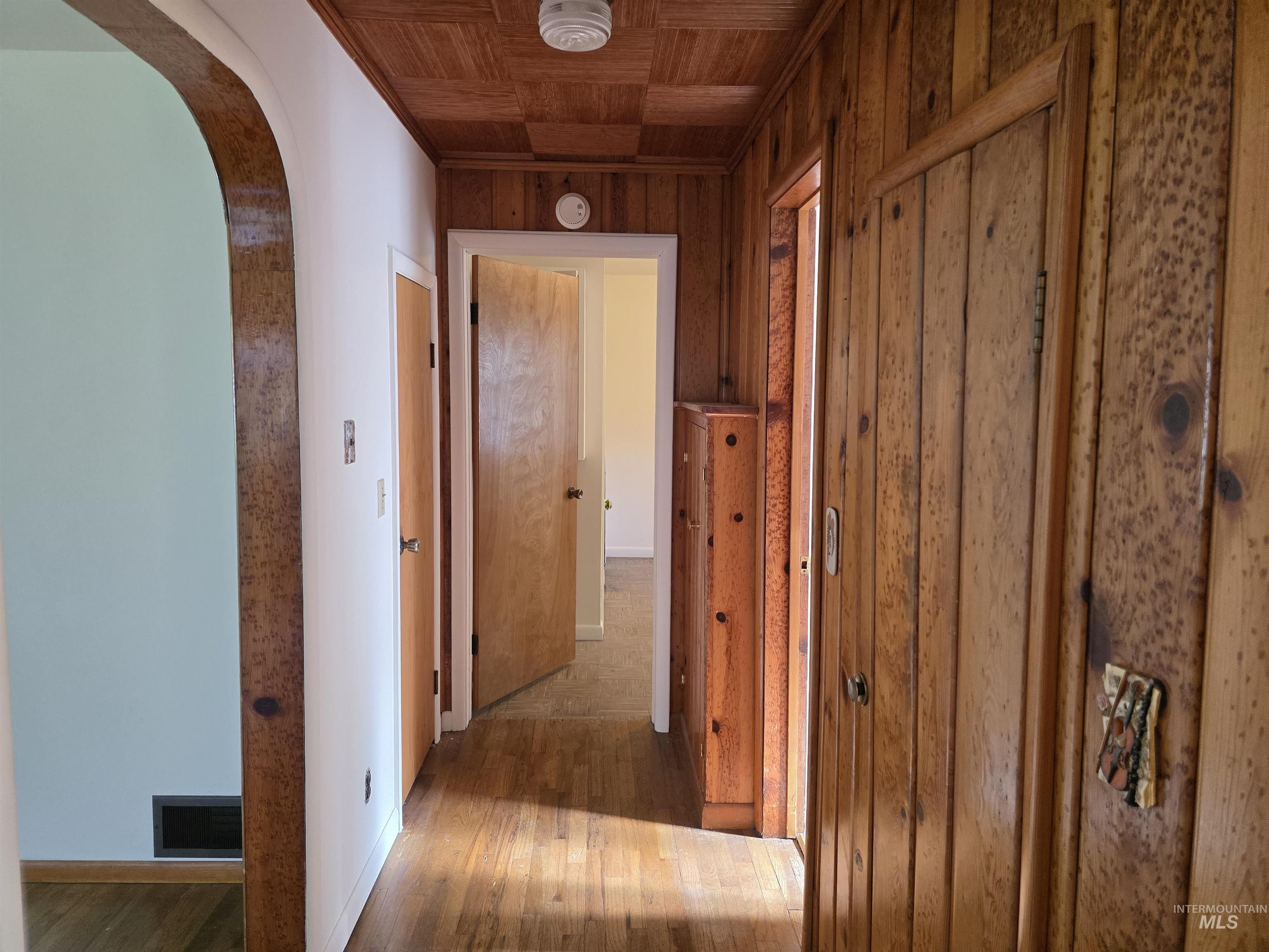 909 12th Street Kamiah, ID 83536 - Photo 14 of 36 Corridor featuring arched walkways, hardwood / wood-style flooring, and wood walls