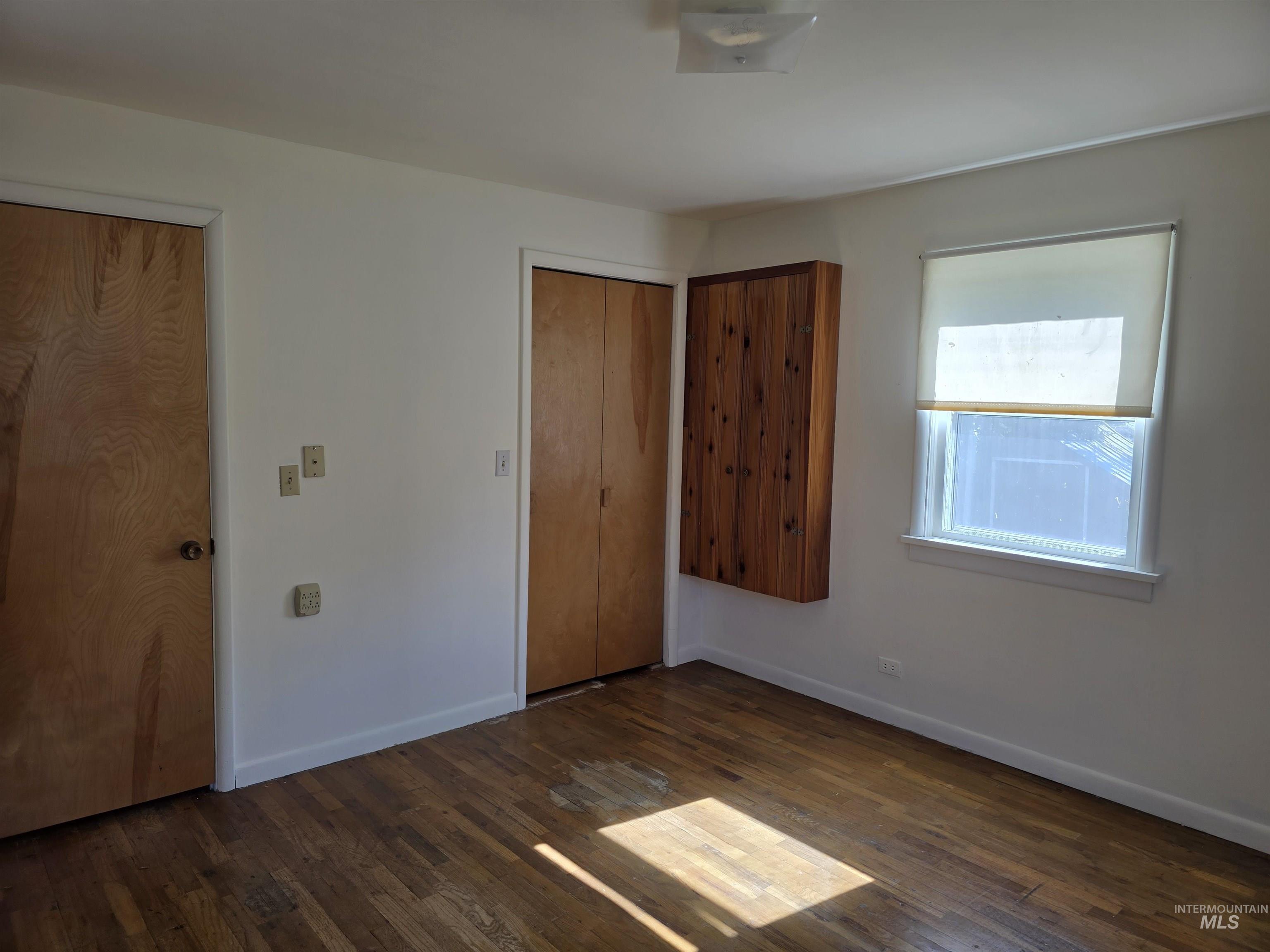909 12th Street Kamiah, ID 83536 - Photo 16 of 36 Unfurnished bedroom with dark wood-style floors
