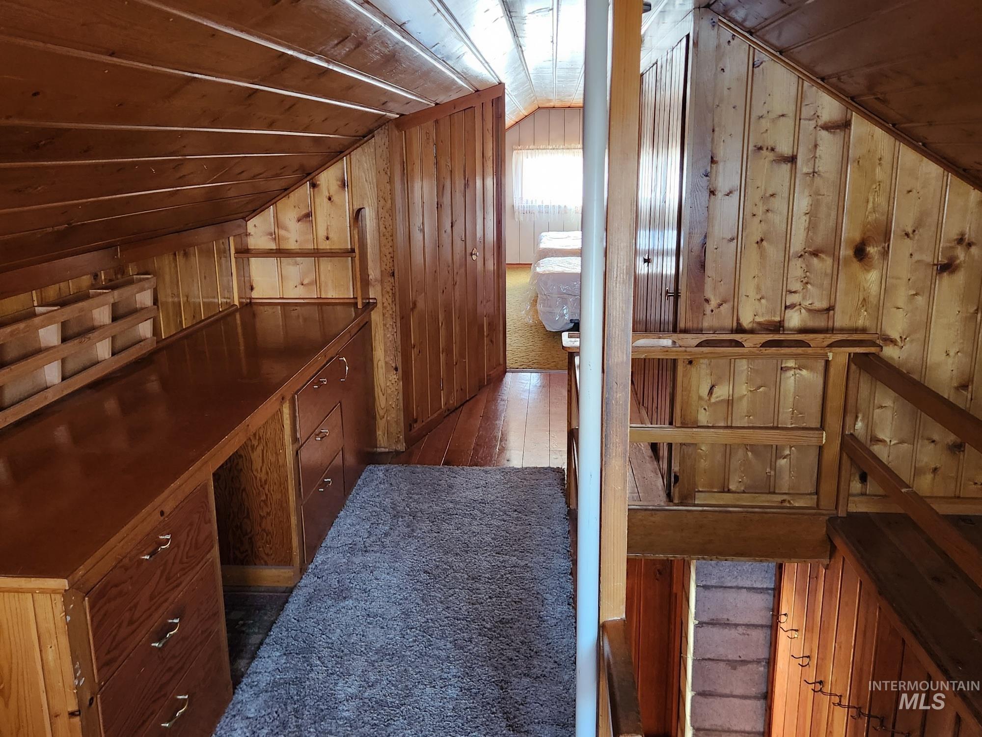 909 12th Street Kamiah, ID 83536 - Photo 20 of 36 Hall featuring wood walls, lofted ceiling, and dark wood-style floors