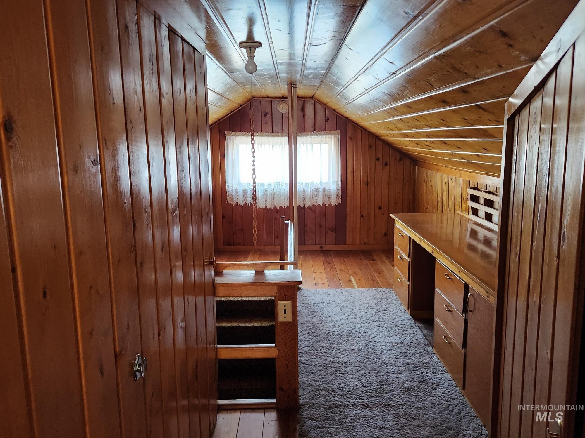 909 12th Street Kamiah, ID 83536 - Photo 21 of 36 Bonus room with light wood-style floors, wood walls, and vaulted ceiling