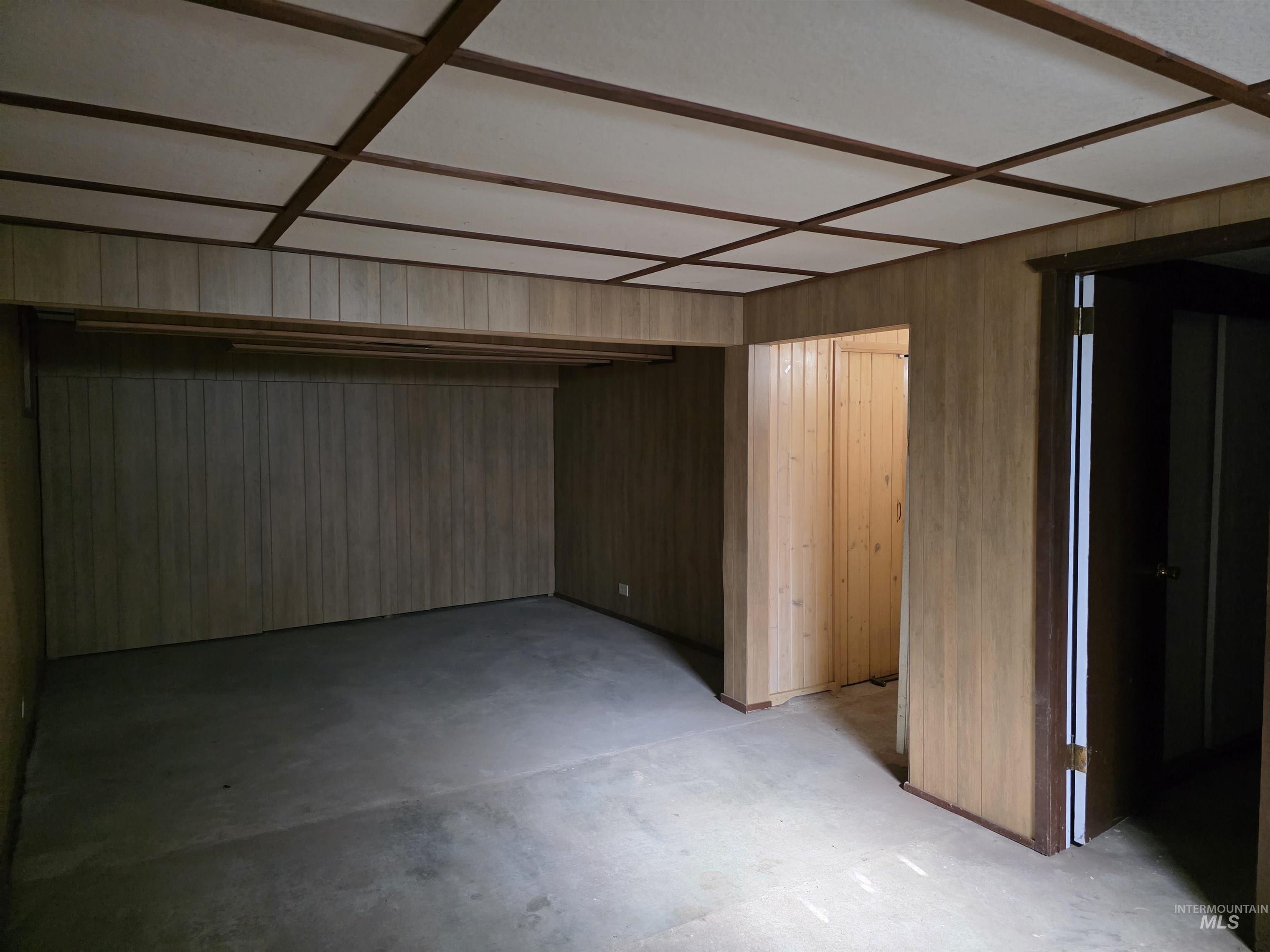 909 12th Street Kamiah, ID 83536 - Photo 25 of 36 Unfurnished bedroom featuring concrete flooring and wood walls