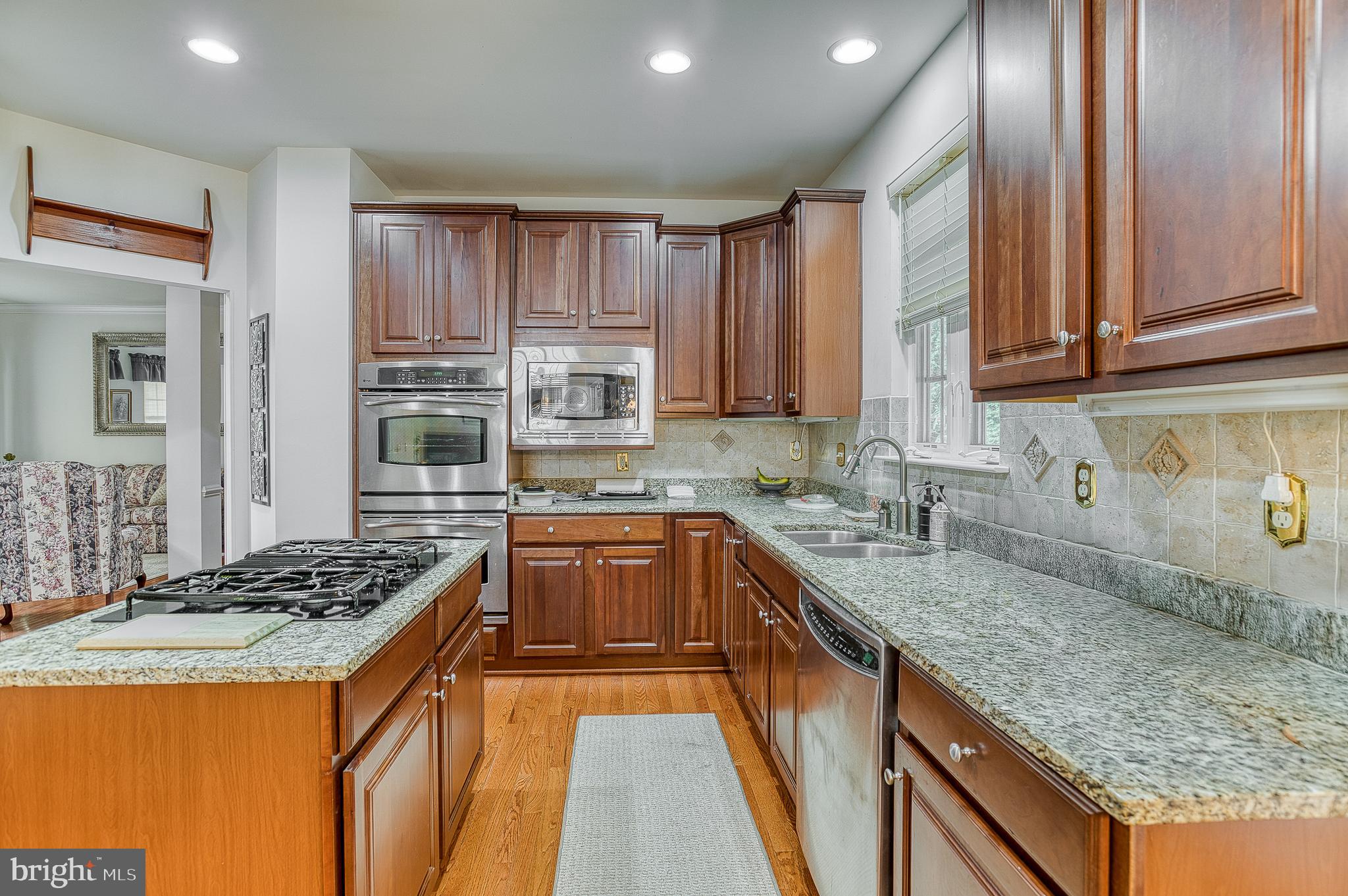 687 Hunters Road Culpeper, VA 22701 - Photo 18 of 57 a kitchen with granite countertop a sink stove and cabinets