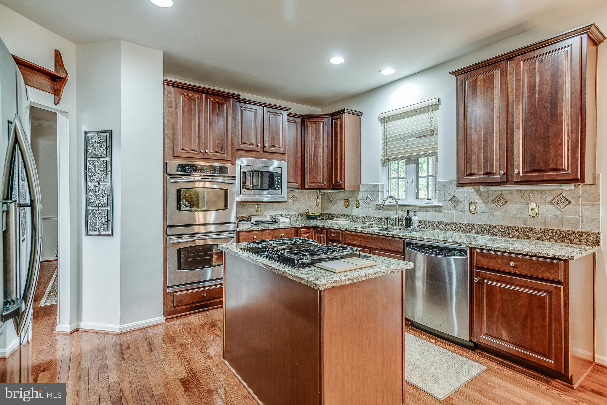 687 Hunters Road Culpeper, VA 22701 - Photo 19 of 57 a kitchen with kitchen island granite countertop wooden cabinets stainless steel appliances and a sink