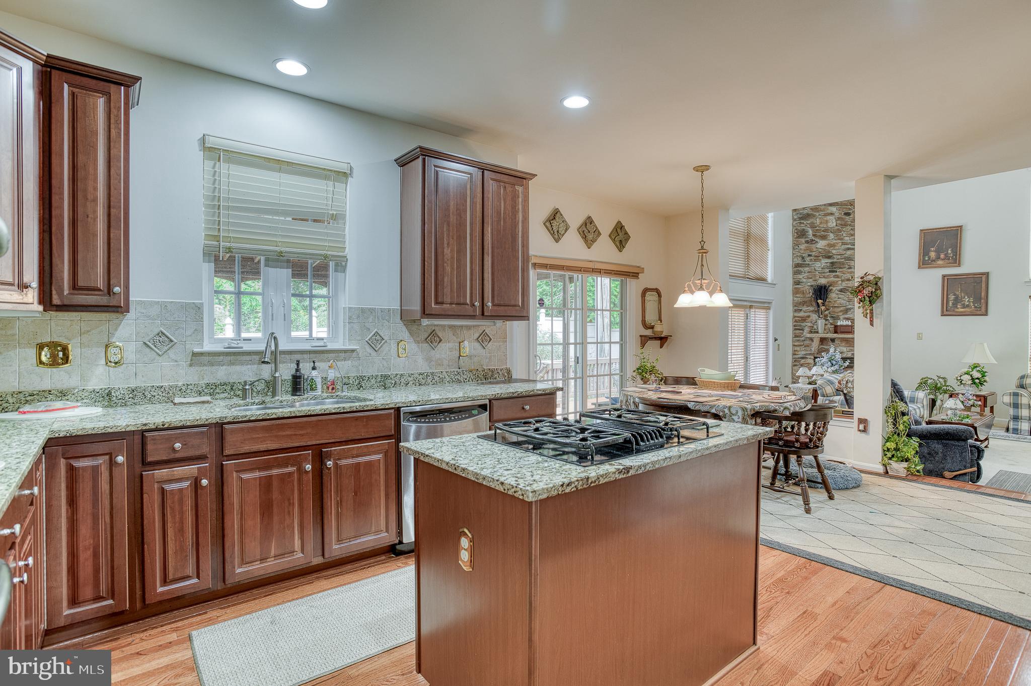 687 Hunters Road Culpeper, VA 22701 - Photo 20 of 57 a kitchen with stainless steel appliances granite countertop wooden cabinets a stove a sink and a wooden floors