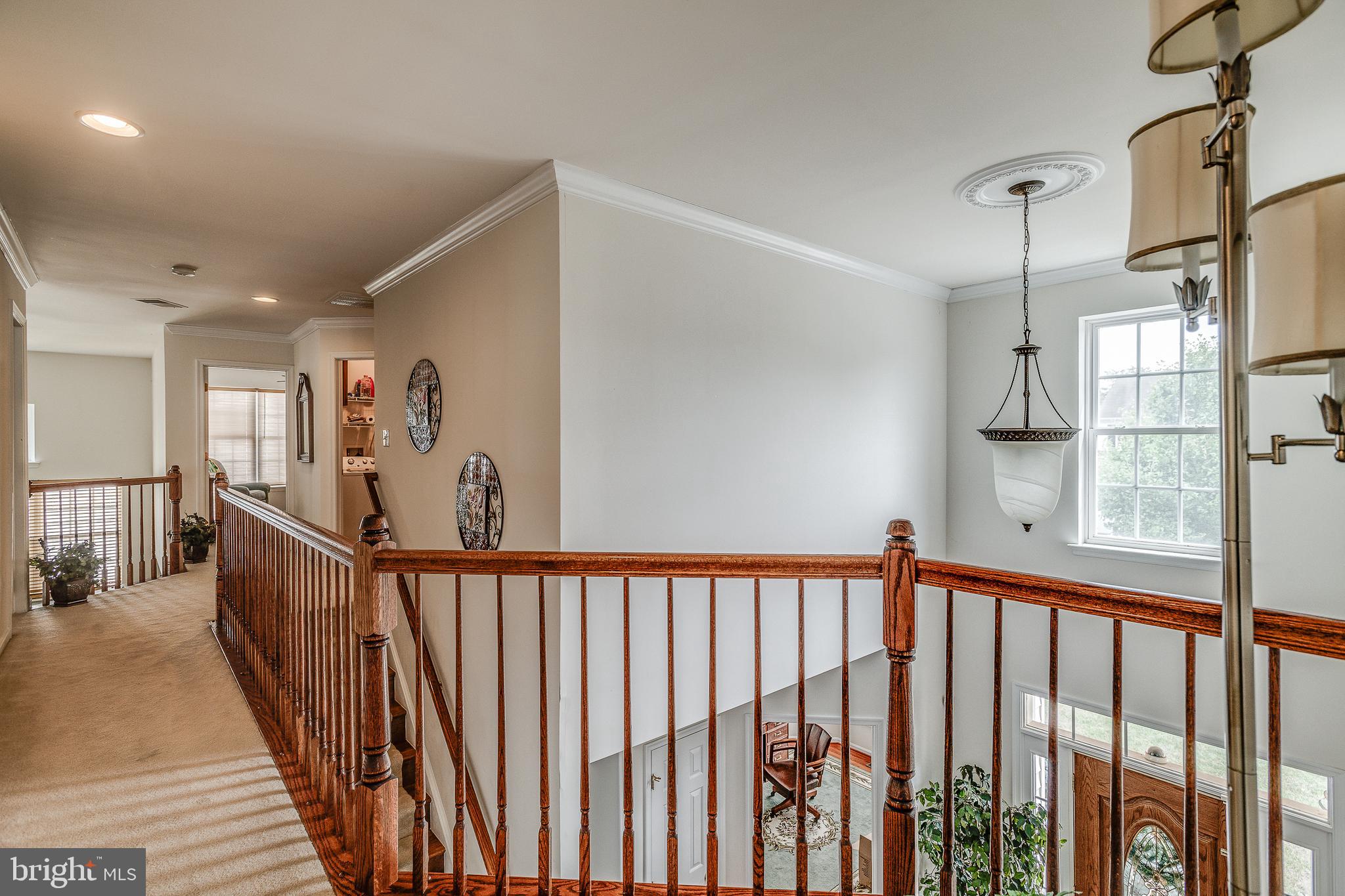 687 Hunters Road Culpeper, VA 22701 - Photo 22 of 57 a view of a hallway with wooden floor and stairs