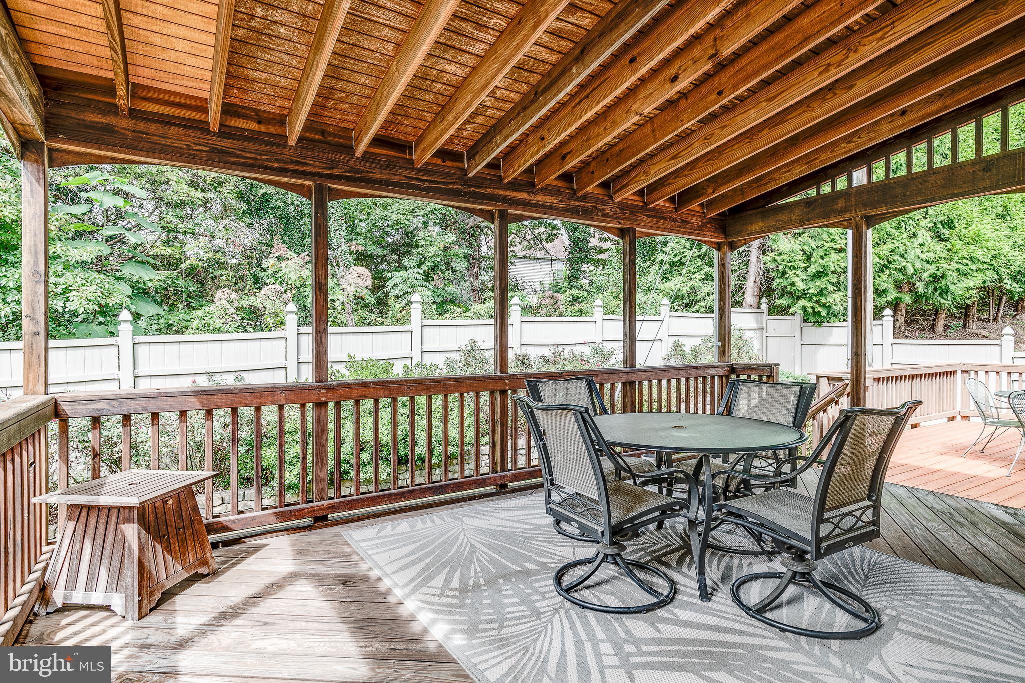 687 Hunters Road Culpeper, VA 22701 - Photo 43 of 57 a view of a patio with table and chairs a barbeque with wooden floor and roof with a garden view