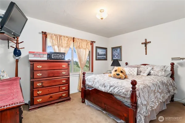a bedroom with a bed and a wooden floor