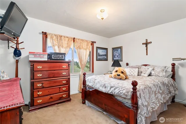 a bedroom with a bed and a wooden floor