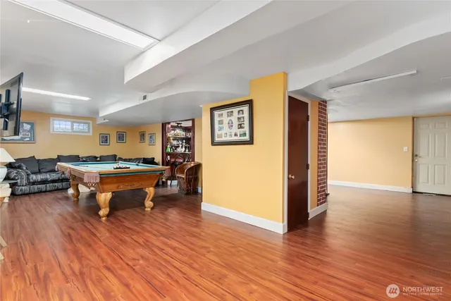a view of a livingroom with wooden floor and staircase