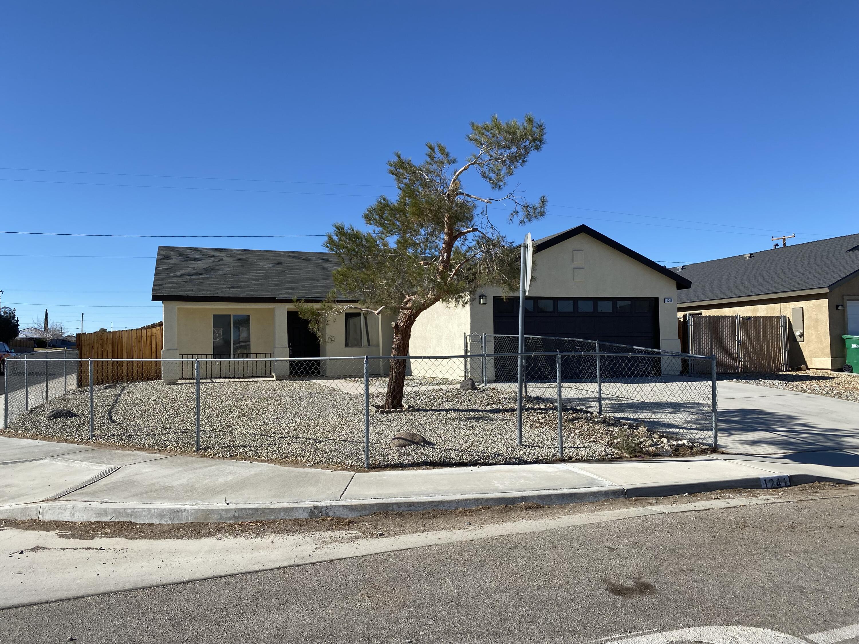 1241 South Ranger Street Ridgecrest, CA 93555 - Photo 1 of 26 a front view of a house with garden