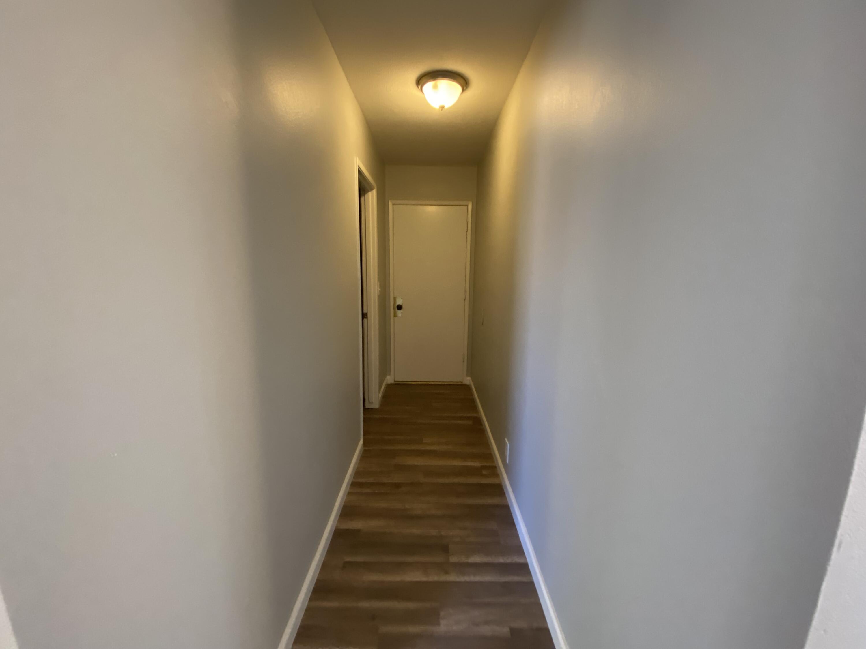 1241 South Ranger Street Ridgecrest, CA 93555 - Photo 13 of 26 a view of a hallway with wooden floor