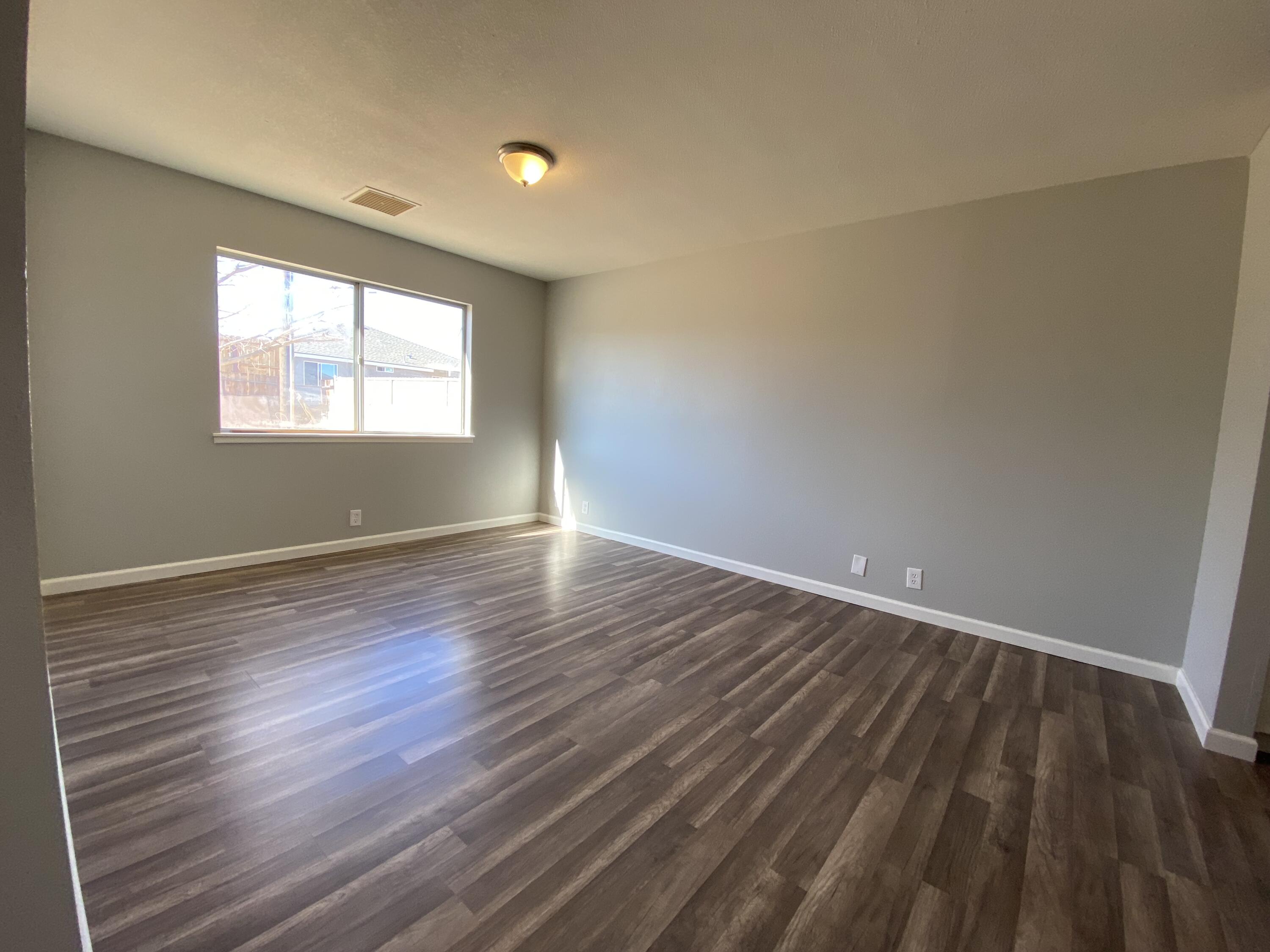 1241 South Ranger Street Ridgecrest, CA 93555 - Photo 15 of 26 wooden floor in an empty room with a window