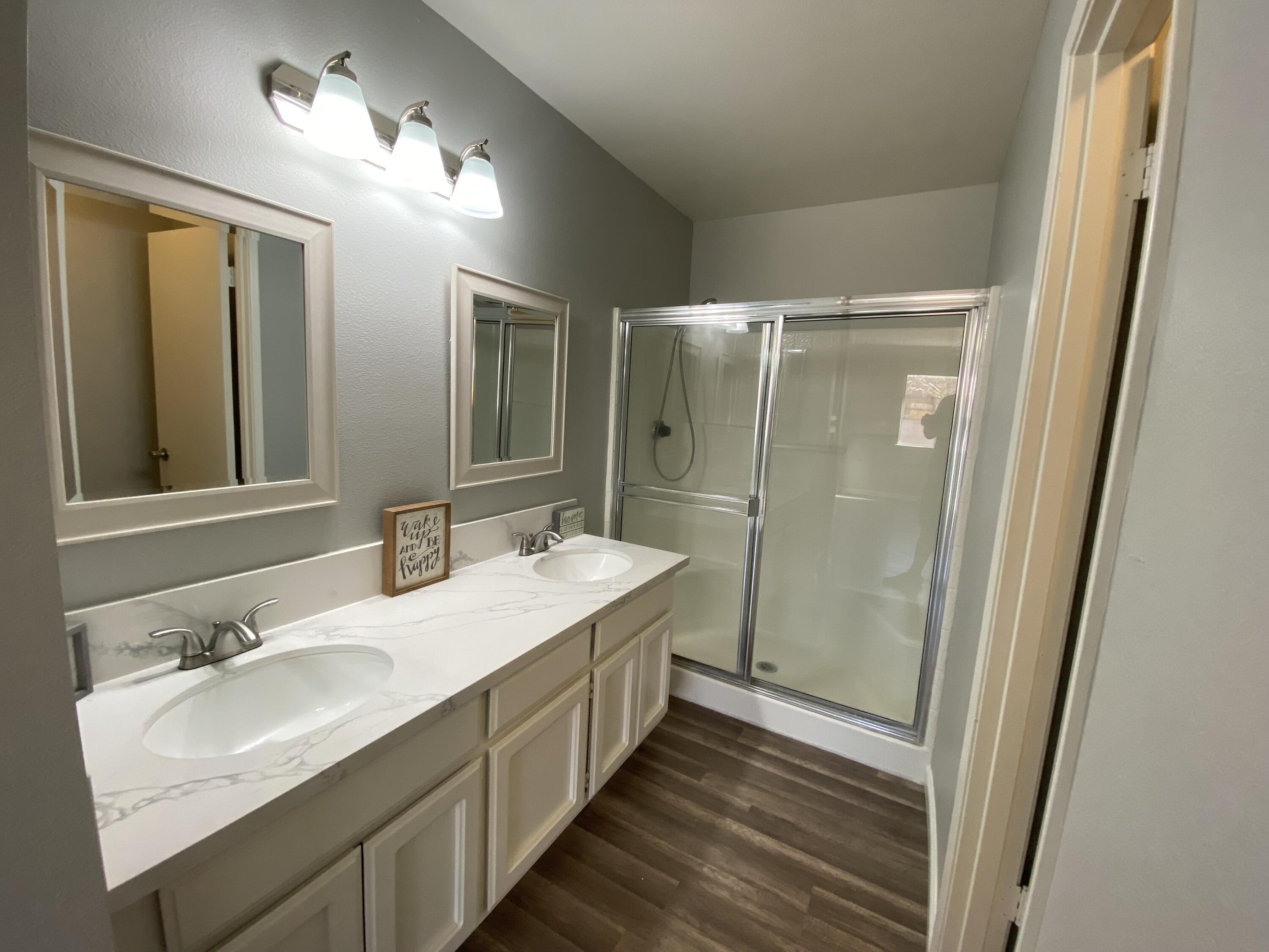 1241 South Ranger Street Ridgecrest, CA 93555 - Photo 17 of 26 a bathroom with a double vanity sink mirror and shower