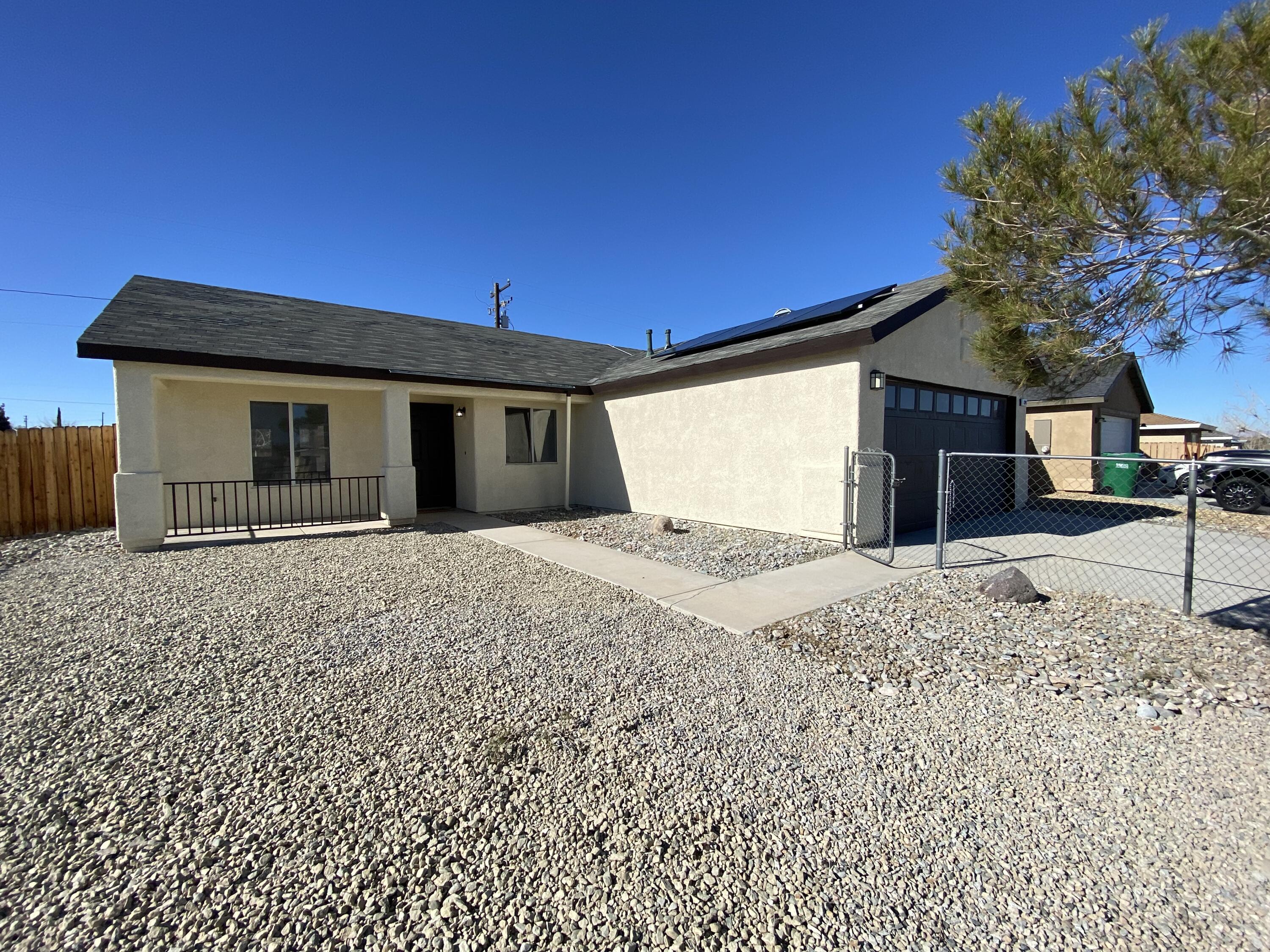 1241 South Ranger Street Ridgecrest, CA 93555 - Photo 2 of 26 a front view of a house with a yard