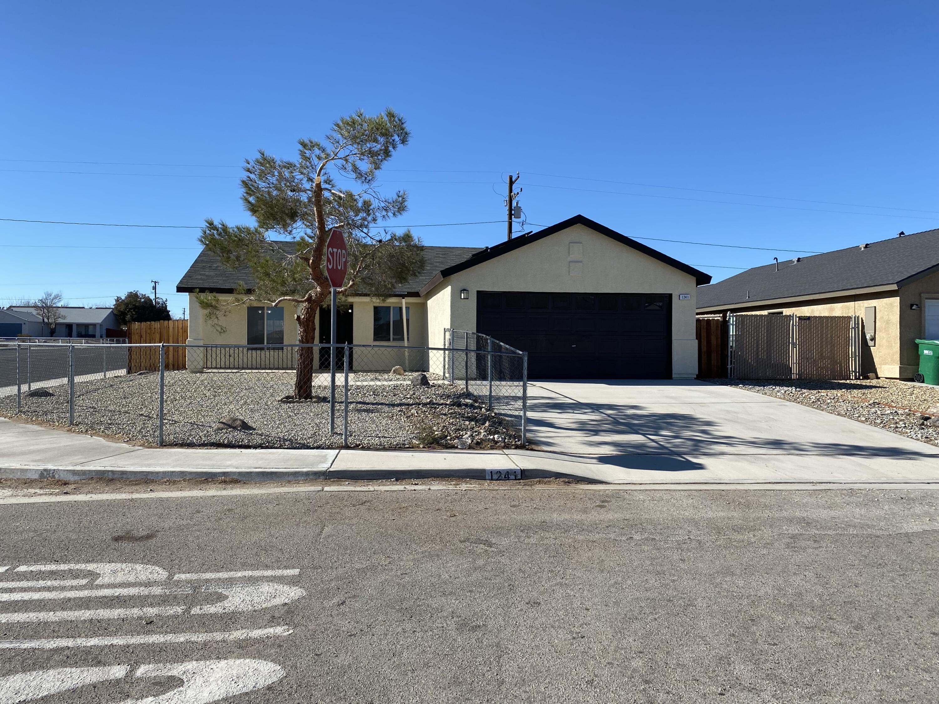 1241 South Ranger Street Ridgecrest, CA 93555 - Photo 3 of 26 a front view of a house with a yard