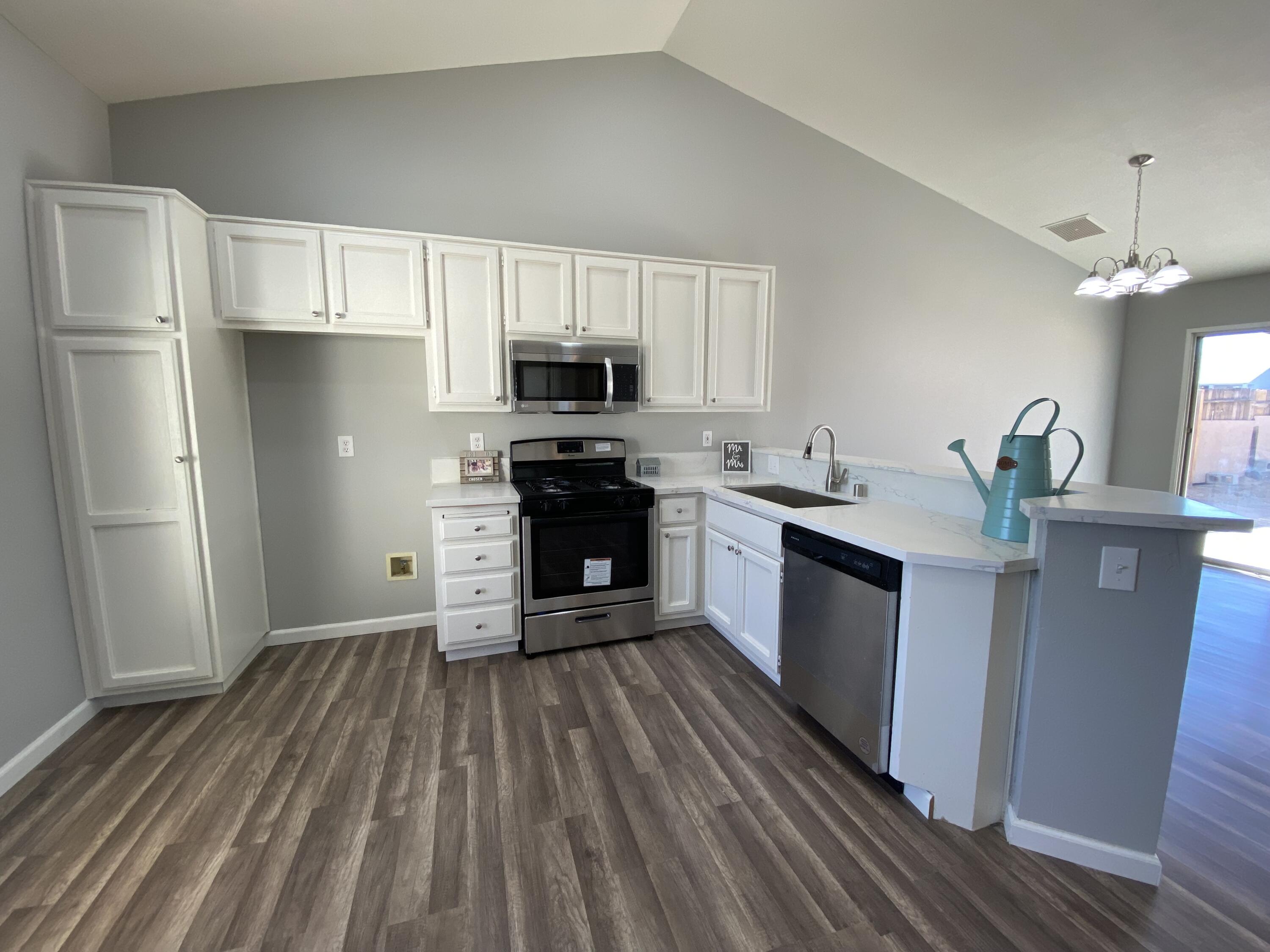 1241 South Ranger Street Ridgecrest, CA 93555 - Photo 8 of 26 a large kitchen with stainless steel appliances granite countertop a stove refrigerator and a sink