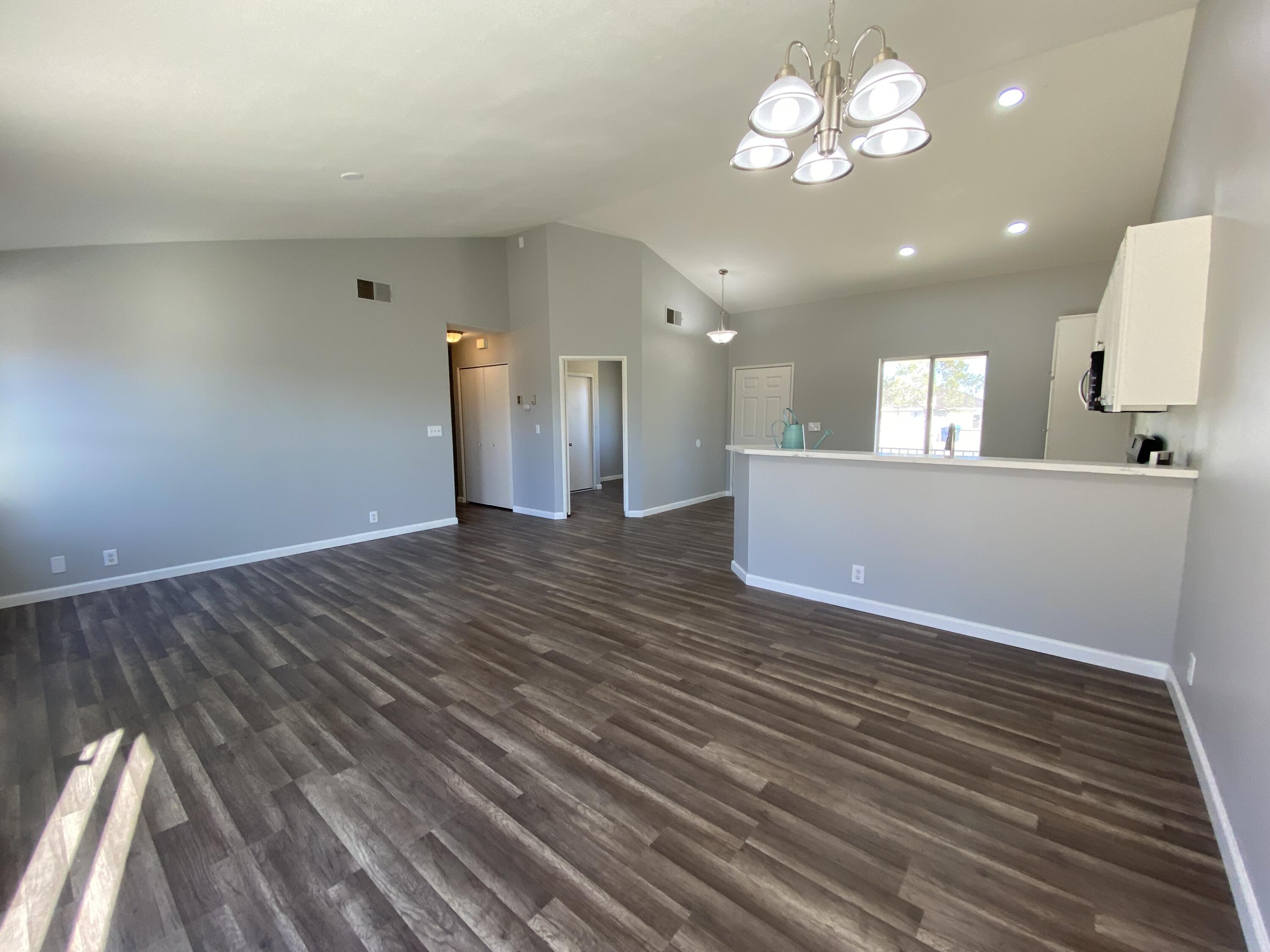 1241 South Ranger Street Ridgecrest, CA 93555 - Photo 9 of 26 a view of a room with wooden floor and a ceiling fan
