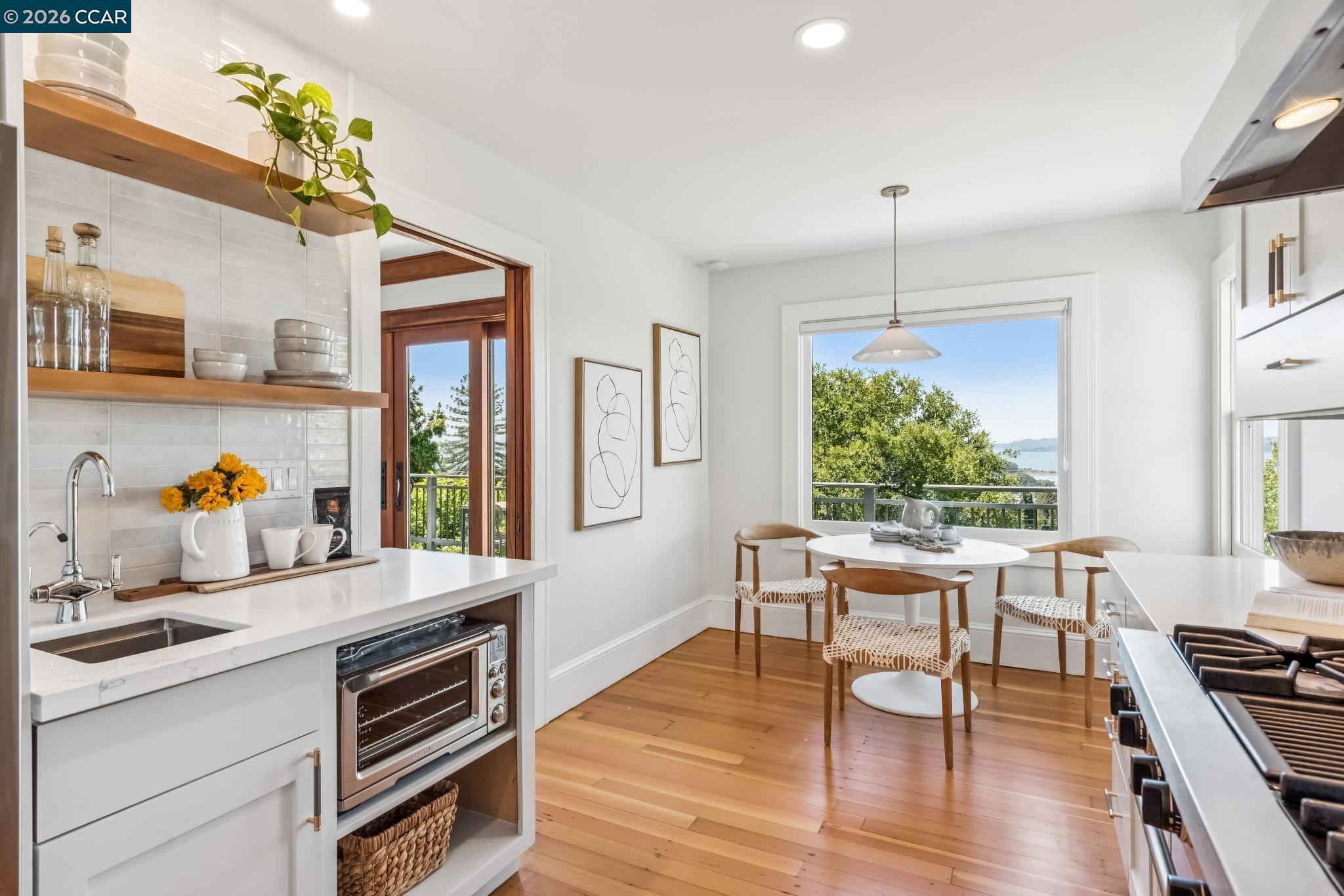 212 Yale Avenue Kensington, CA 94708 - Photo 24 of 70 a dining room with wooden floor a chandelier a wooden table and chairs