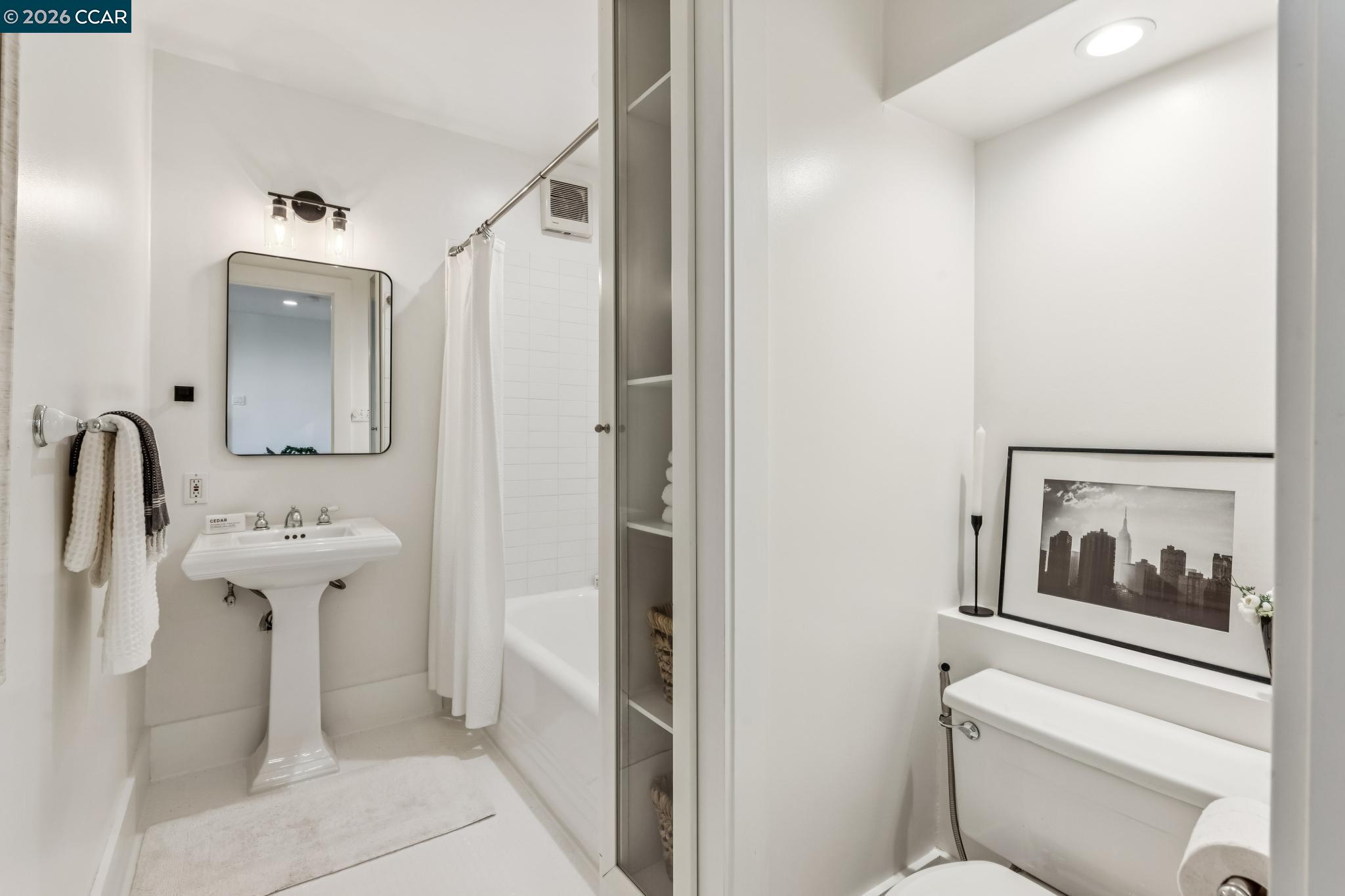 212 Yale Avenue Kensington, CA 94708 - Photo 35 of 70 a bathroom with a sink and mirror with toilet