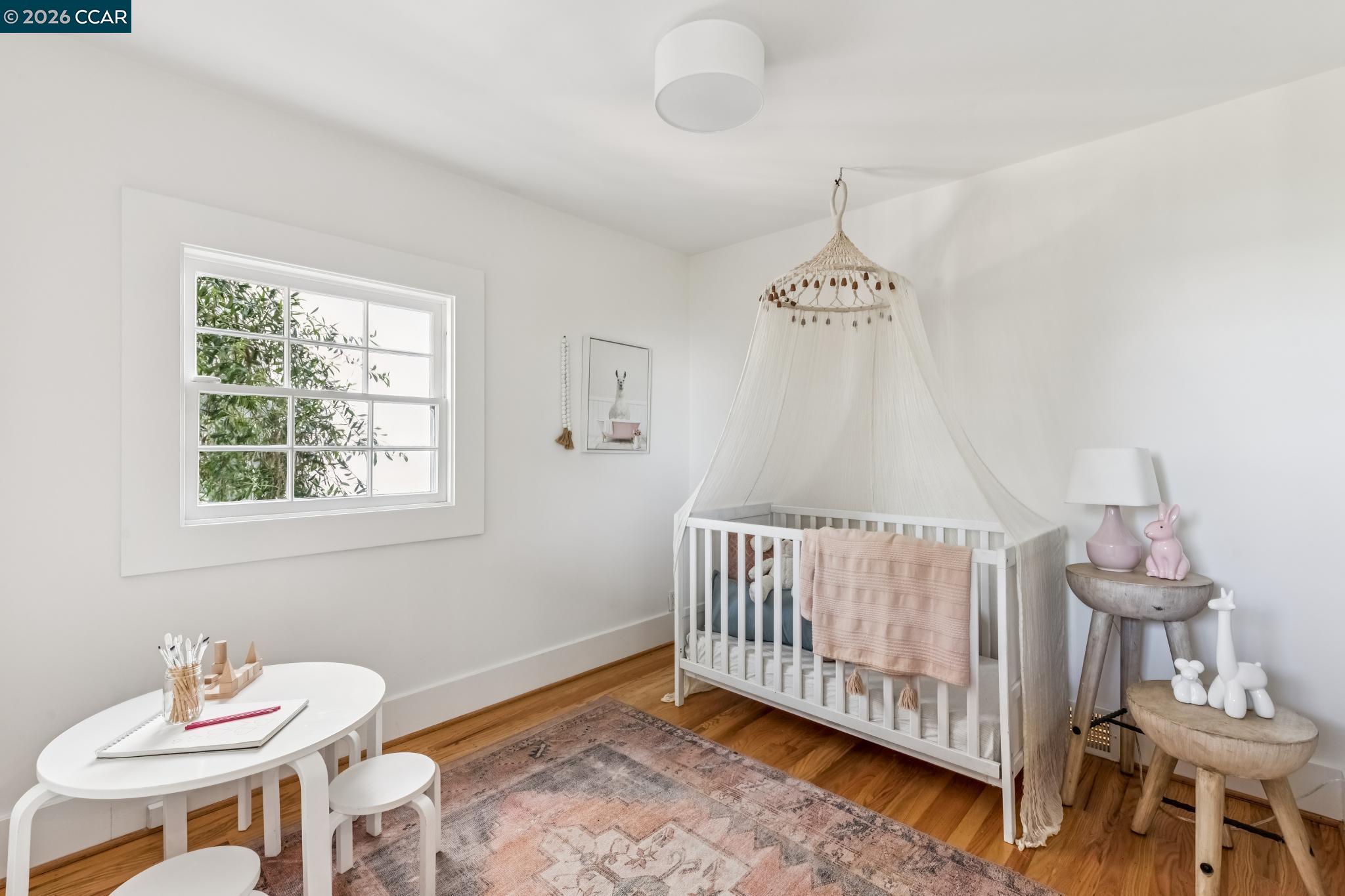 212 Yale Avenue Kensington, CA 94708 - Photo 43 of 70 a bedroom with a bed and a chandelier fan