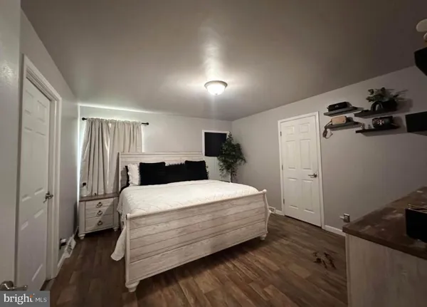 a room with a bed and a dresser