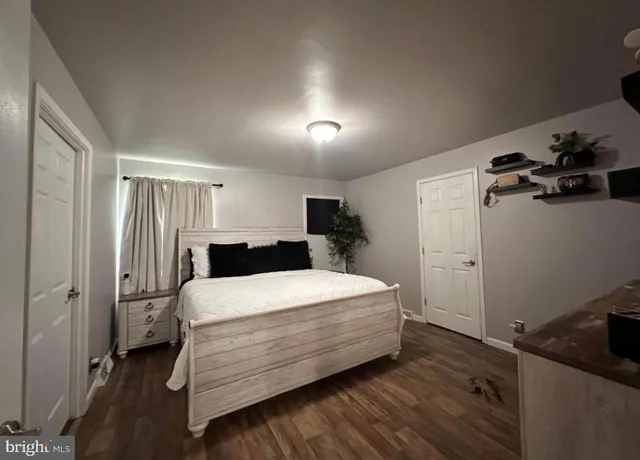 a room with a bed and a dresser