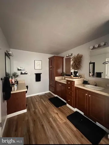 a kitchen with stainless steel appliances kitchen island granite countertop a sink dishwasher stove and refrigerator