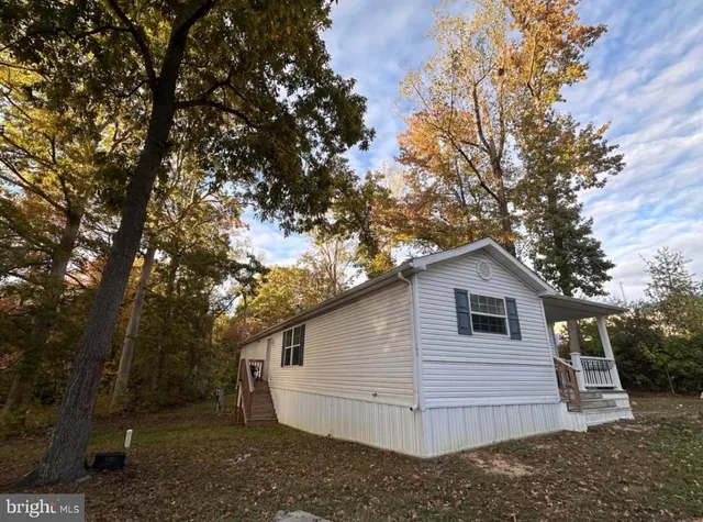 a view of a small house in middle of the forest
