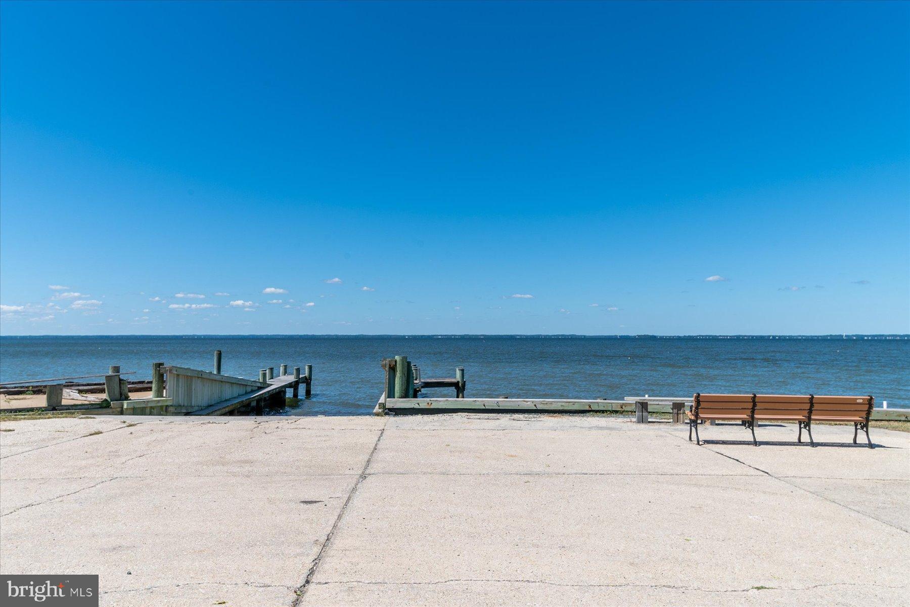 109 Calvert Road Stevensville, MD 21666 - Photo 8 of 41 Serene waterfront view with inviting benches.