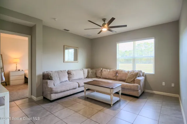 a bedroom with a bed a window and a chandelier