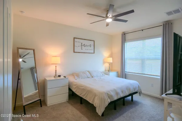 a bedroom with a bed and a lamp on table