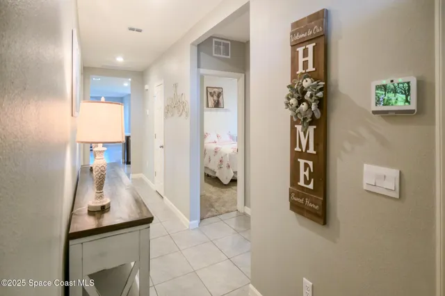 a hallway with a dining table and chairs