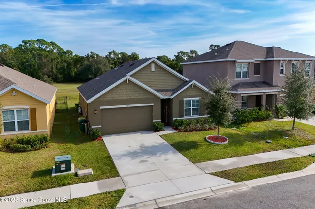 an aerial view of residential houses with outdoor space and boat
