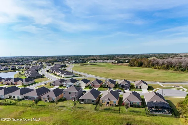 an aerial view of residential houses with outdoor space