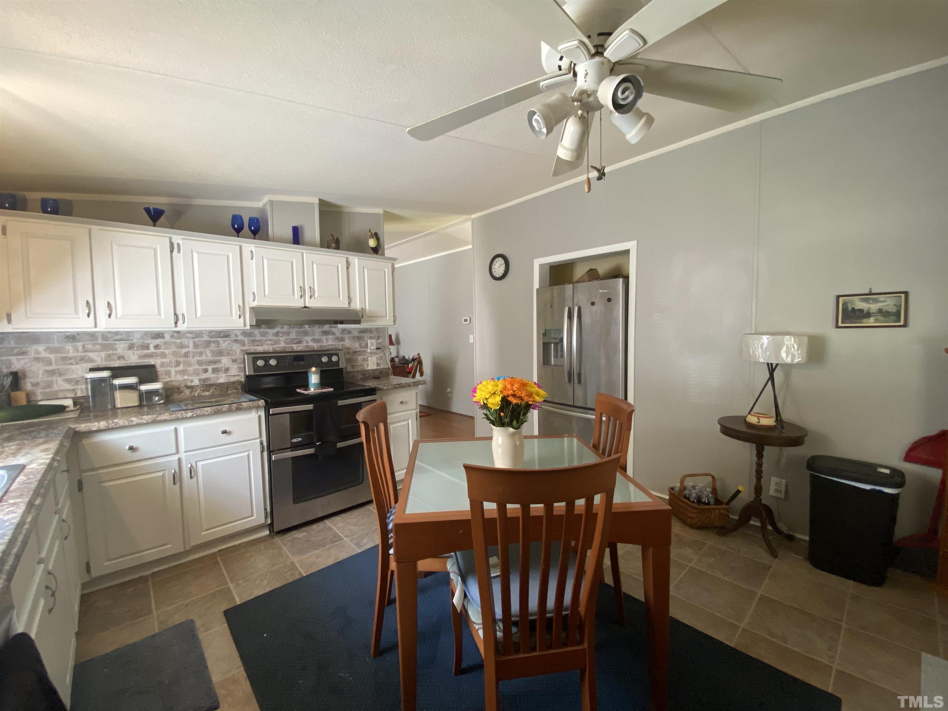 319 Cousin Road Rougemont, NC 27572 - Photo 6 of 17 a kitchen with granite countertop a sink appliances and cabinets